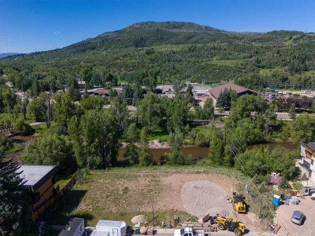 a view of a patio with table and chairs under an umbrella