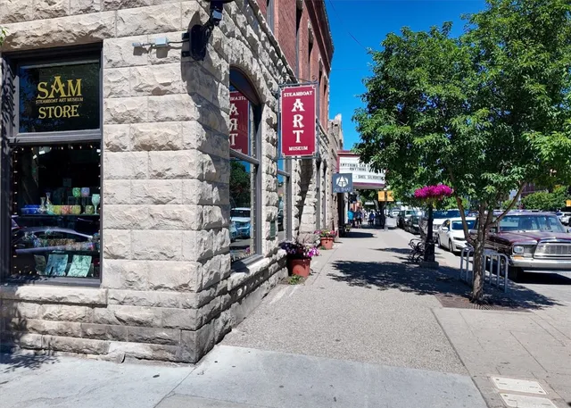 a front view of a building with table and chairs