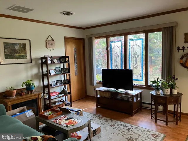 a living room with furniture and a flat screen tv