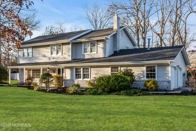 a front view of house with yard and green space
