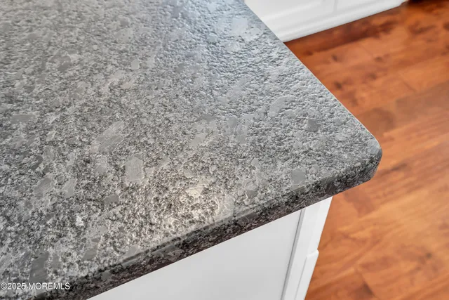 a kitchen with stainless steel appliances granite countertop a sink window and cabinets