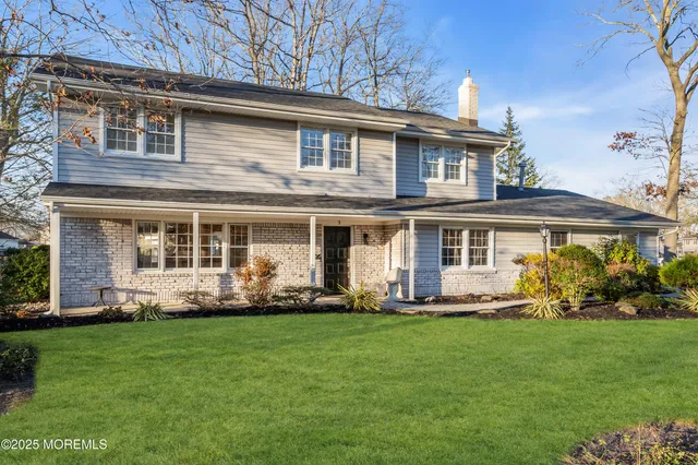 a front view of a house with a yard and plants