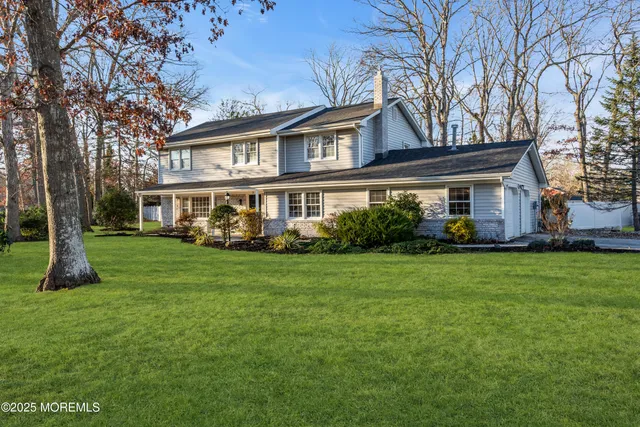 a front view of house with yard and green space