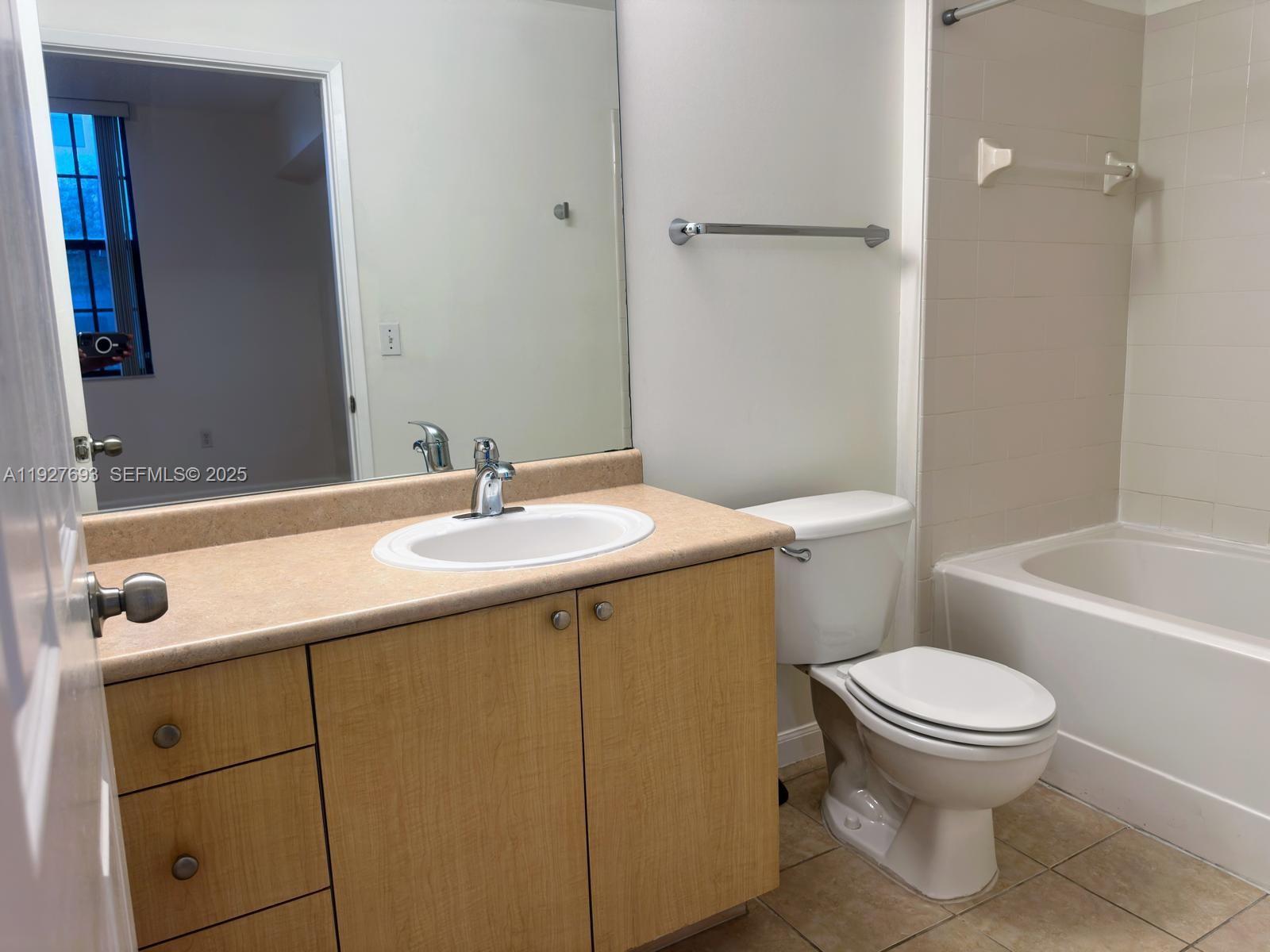 1919 Van Buren Street, Unit 118A Hollywood, FL 33020 - Photo 18 of 36 a bathroom with a sink toilet vanity and shower