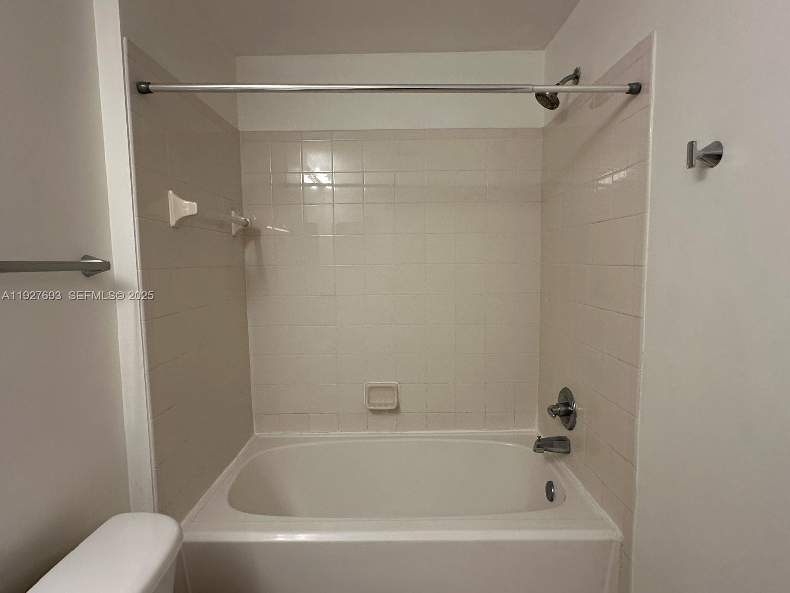 1919 Van Buren Street, Unit 118A Hollywood, FL 33020 - Photo 19 of 36 a bathroom with a bathtub and a shower