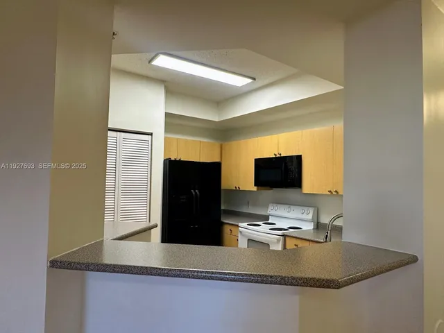 a kitchen with a sink and a refrigerator