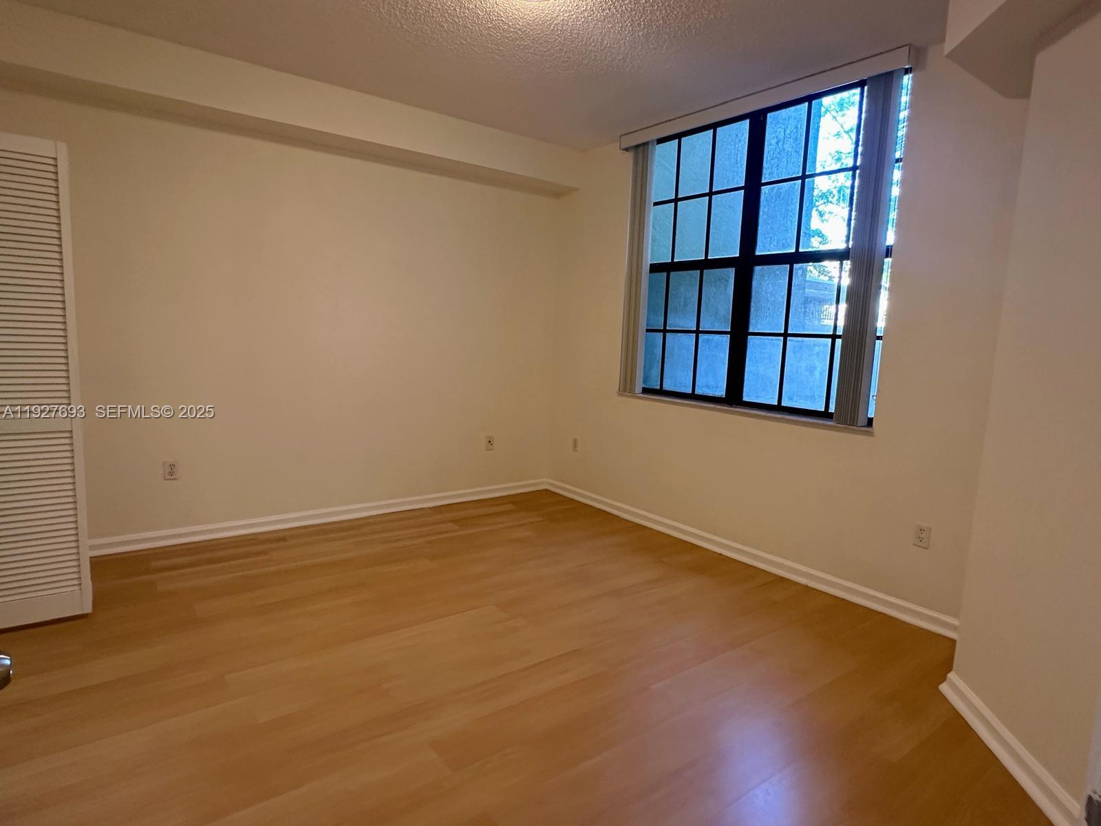 1919 Van Buren Street, Unit 118A Hollywood, FL 33020 - Photo 23 of 36 an empty room with windows and closet