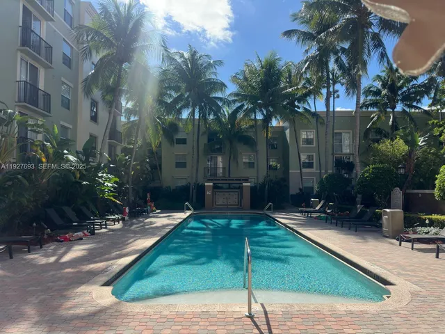a view of a chairs and tables in the patio in front of a house