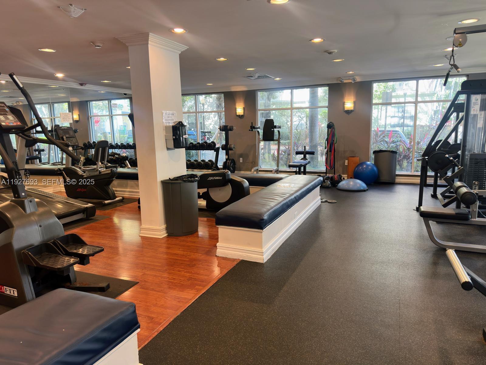 1919 Van Buren Street, Unit 118A Hollywood, FL 33020 - Photo 33 of 36 a living room with furniture gym equipment and a large window