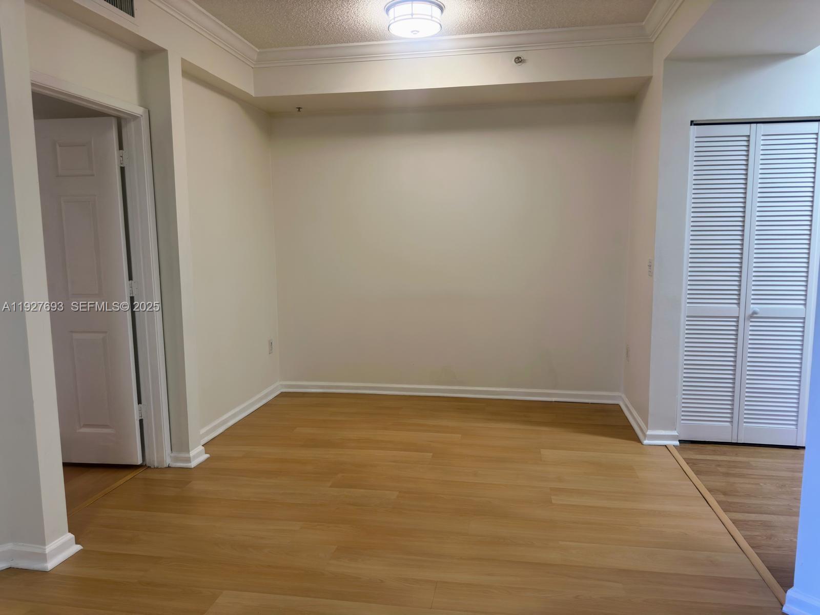 1919 Van Buren Street, Unit 118A Hollywood, FL 33020 - Photo 7 of 36 a view of an empty room with wooden floor and a window