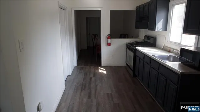 a kitchen with a refrigerator and a stove