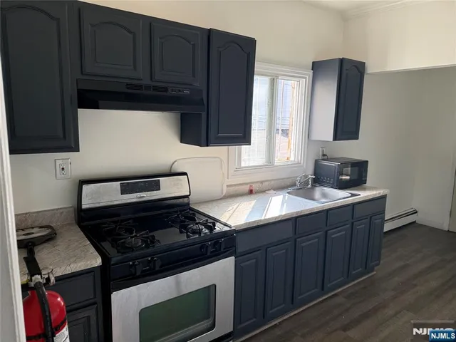 a kitchen with wooden cabinets and a stove top oven