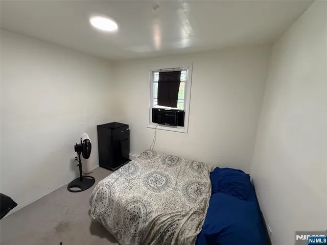 a bedroom with a bed and a lamp