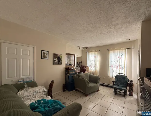 a living room with furniture rug and window