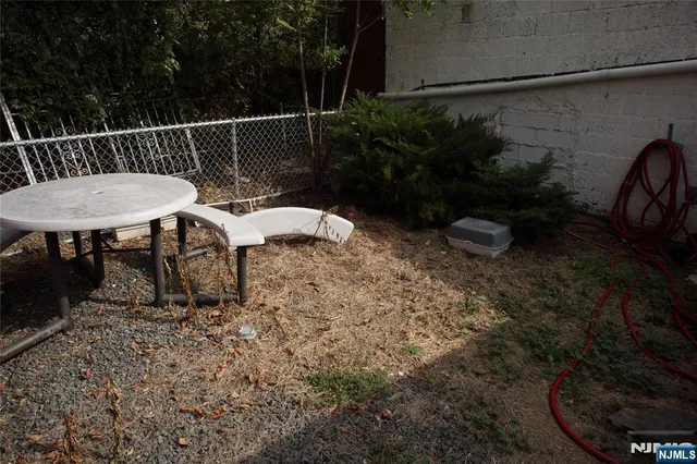 a view of a chairs and table in backyard