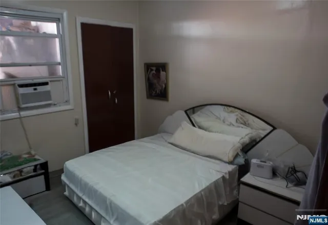 a bedroom with a bed and a mirror