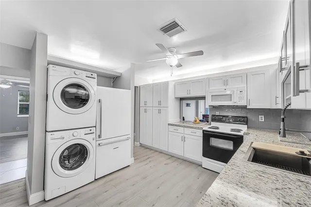 a kitchen with a stove top oven and refrigerator