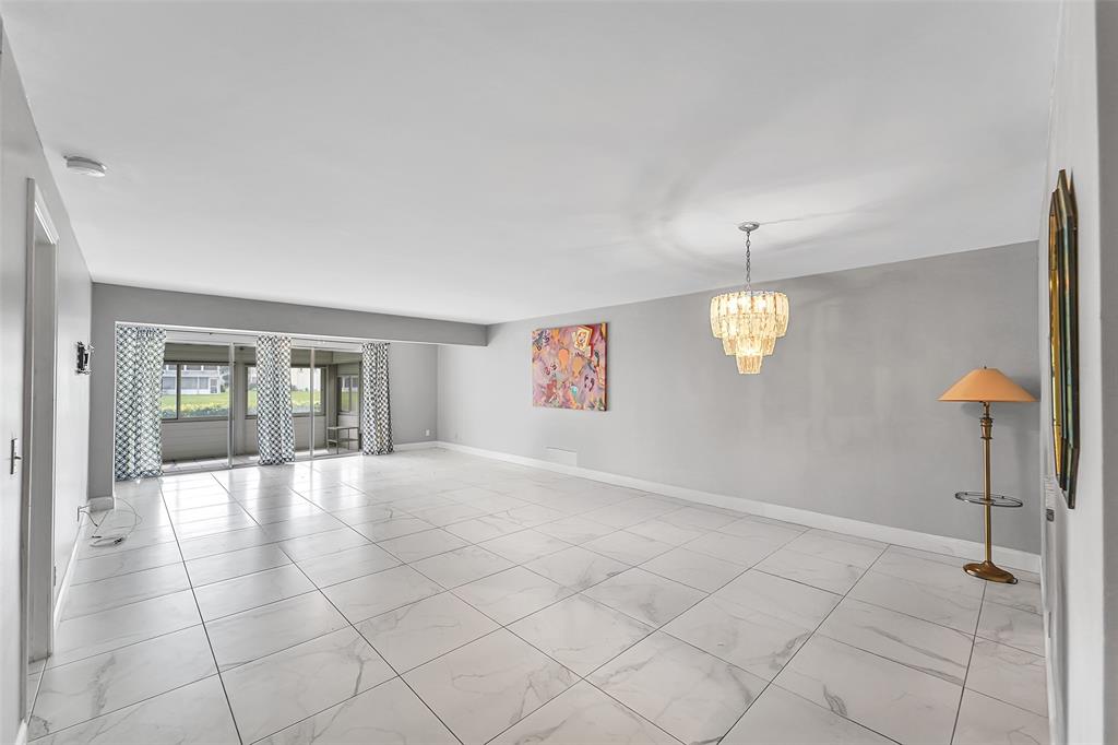 1521 Northwest 19th Terrace, Unit 101 Delray Beach, FL 33445 - Photo 17 of 42 an empty room with windows and fan