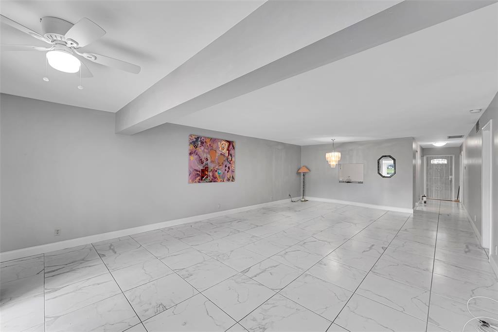 1521 Northwest 19th Terrace, Unit 101 Delray Beach, FL 33445 - Photo 20 of 42 an empty room with windows and fan