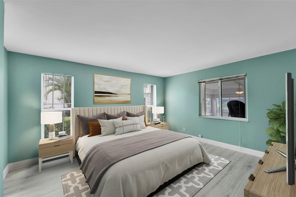 1521 Northwest 19th Terrace, Unit 101 Delray Beach, FL 33445 - Photo 21 of 42 a bedroom with a large bed and a window