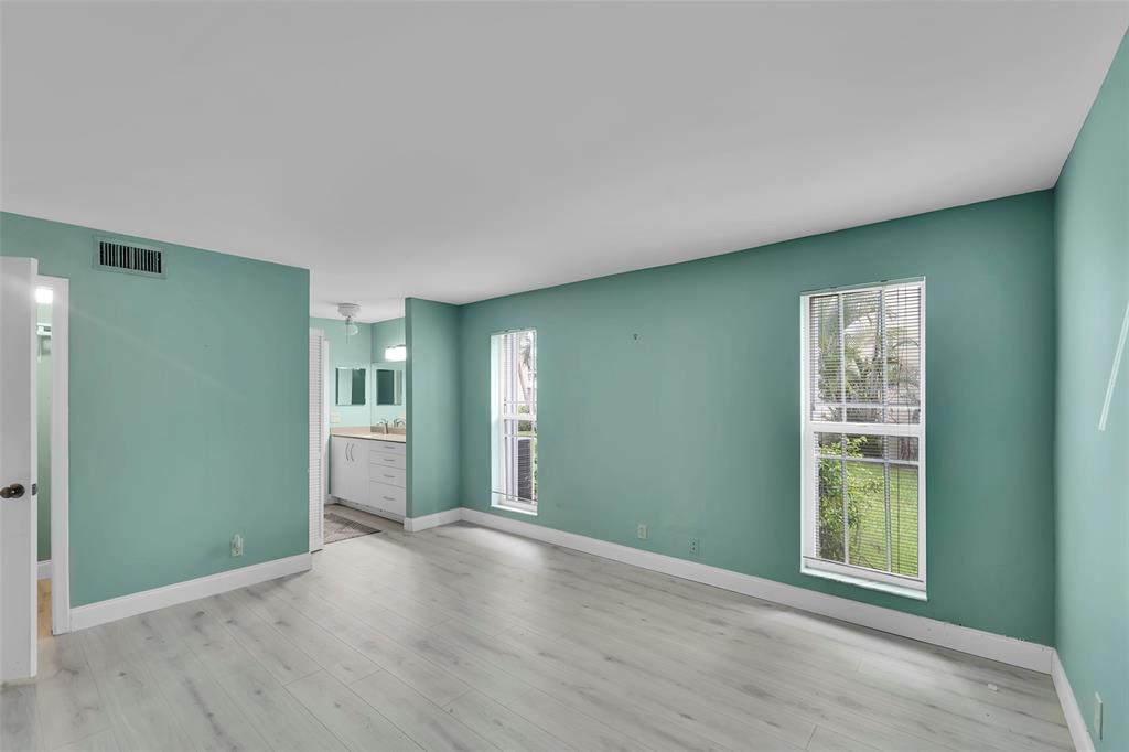 1521 Northwest 19th Terrace, Unit 101 Delray Beach, FL 33445 - Photo 22 of 42 an empty room with closet and windows