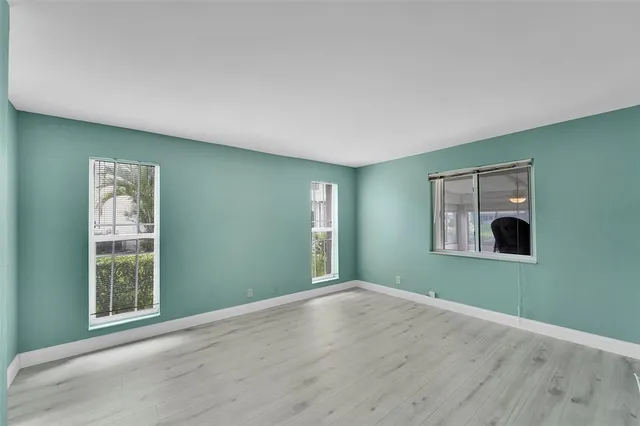 an empty room with windows and closet