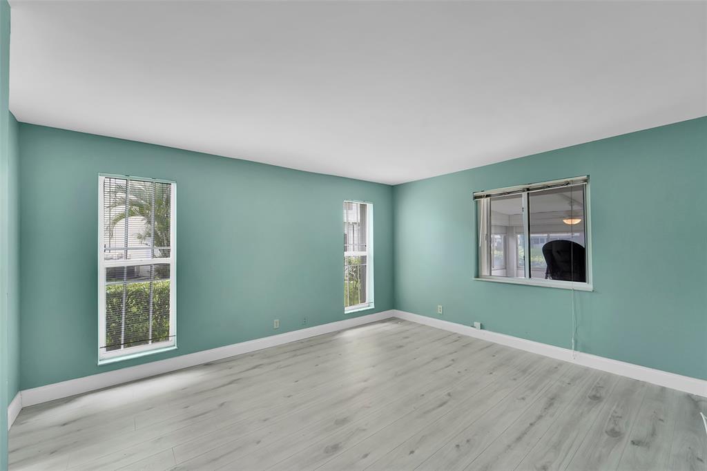 1521 Northwest 19th Terrace, Unit 101 Delray Beach, FL 33445 - Photo 24 of 42 an empty room with windows and closet