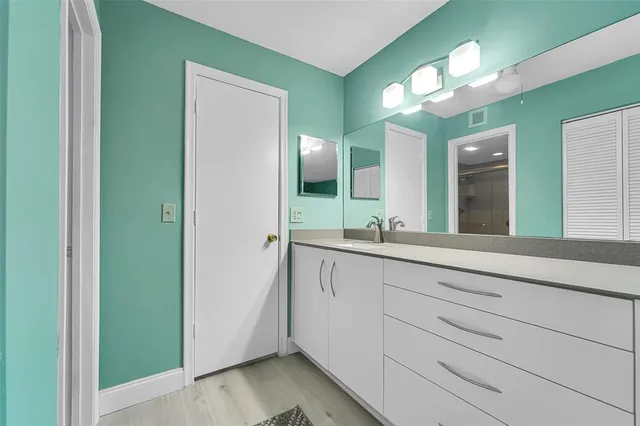 a bathroom with a double vanity sink and a mirror