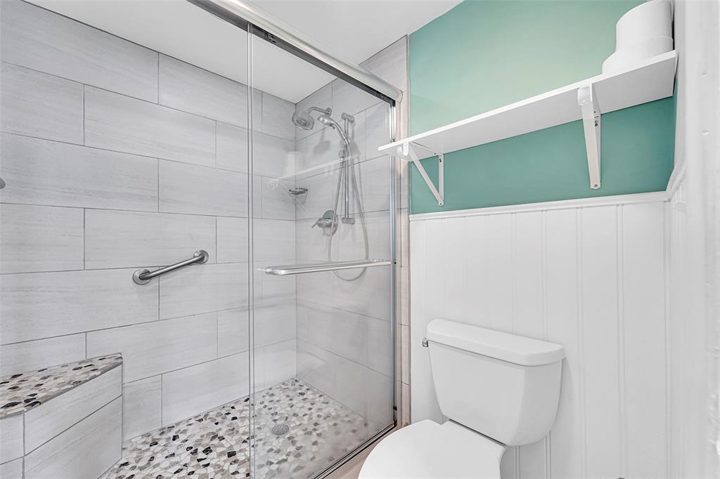 1521 Northwest 19th Terrace, Unit 101 Delray Beach, FL 33445 - Photo 26 of 42 a white toilet sitting next to a bathroom