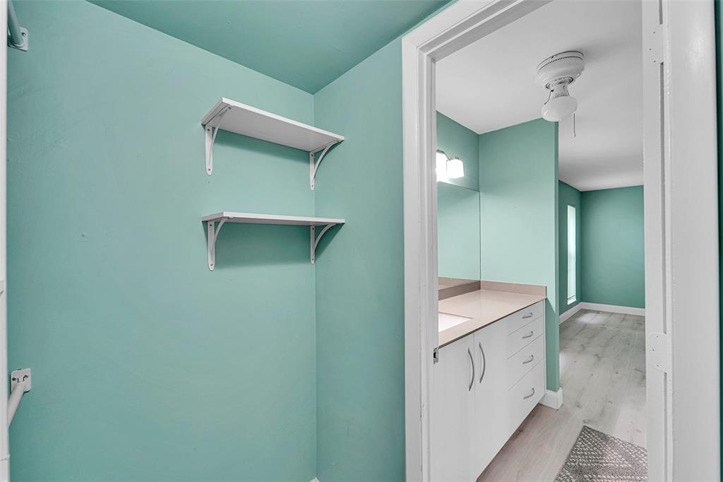 1521 Northwest 19th Terrace, Unit 101 Delray Beach, FL 33445 - Photo 28 of 42 a bathroom with a sink and mirror