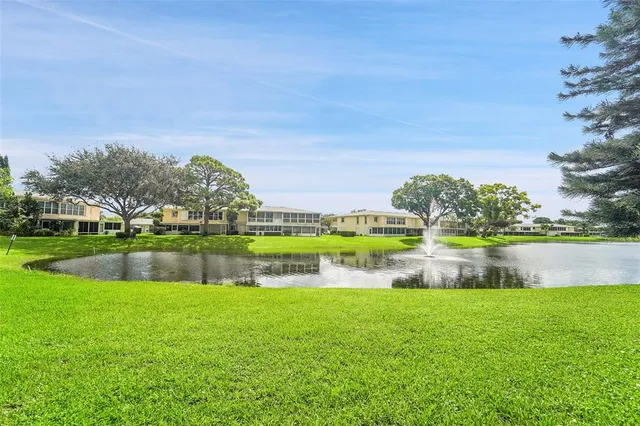 a aerial view of a house with a yard and lake view