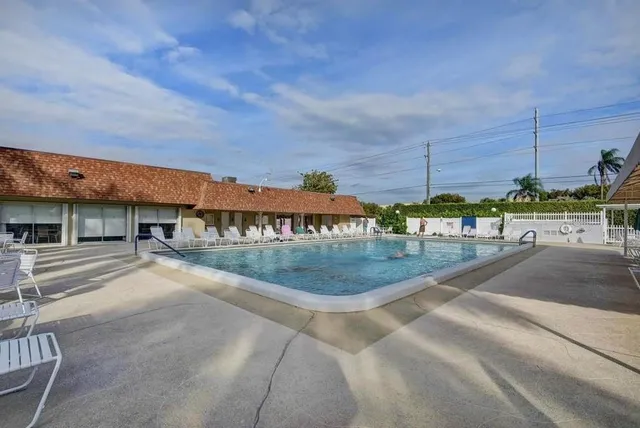a view of a swimming pool with an outdoor seating