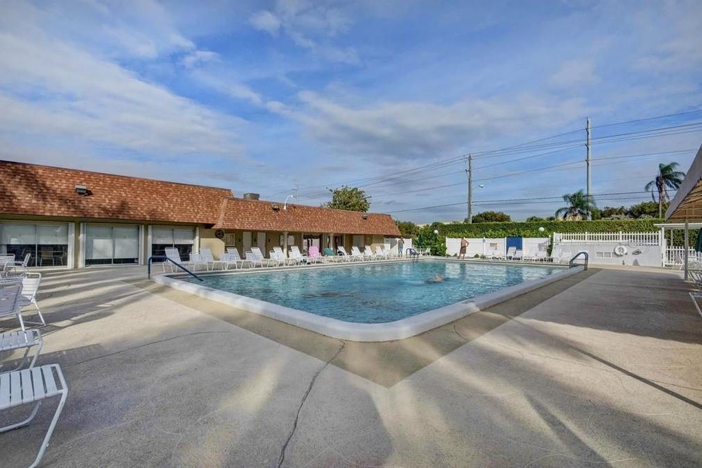 1521 Northwest 19th Terrace, Unit 101 Delray Beach, FL 33445 - Photo 41 of 42 a view of a swimming pool with a yard