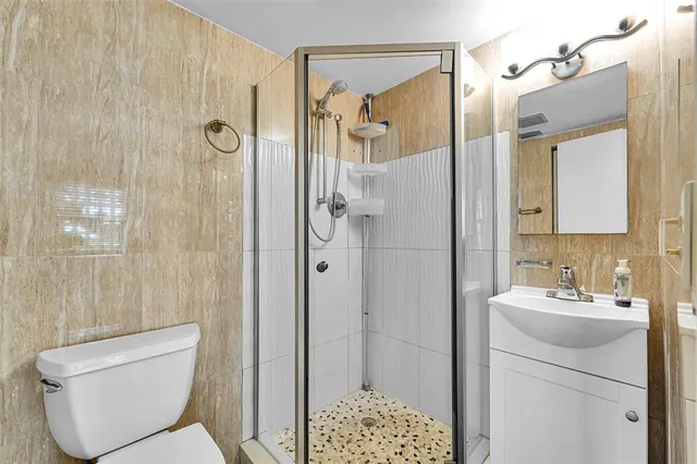 a bathroom with a toilet sink shower and mirror