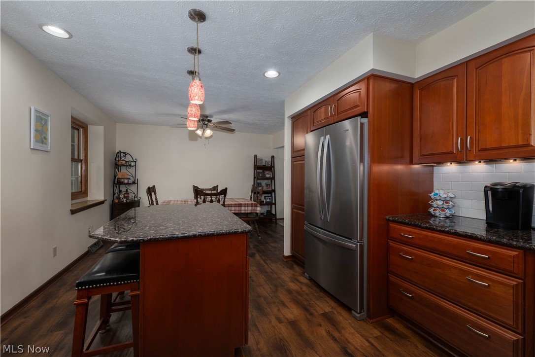 1619 Reed Street Canal Fulton, OH 44614 - Photo 8 of 27 Kitchen featuring wood-finish flooring, soft close dark wood cabinetry, a built-in stainless steel refrigerator, and dark countertops