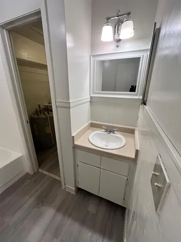 a bathroom with a sink a mirror and a shower