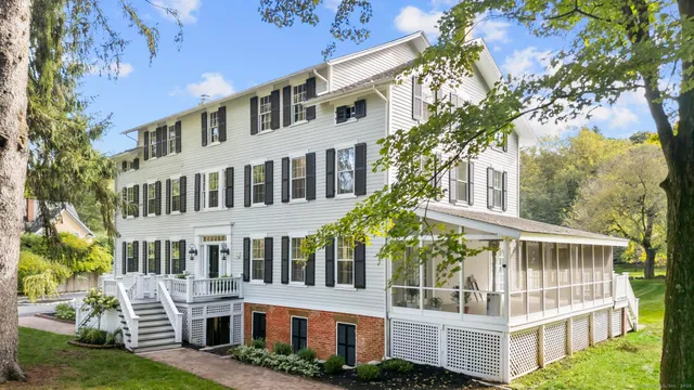 a view of building with large windows and a big yard