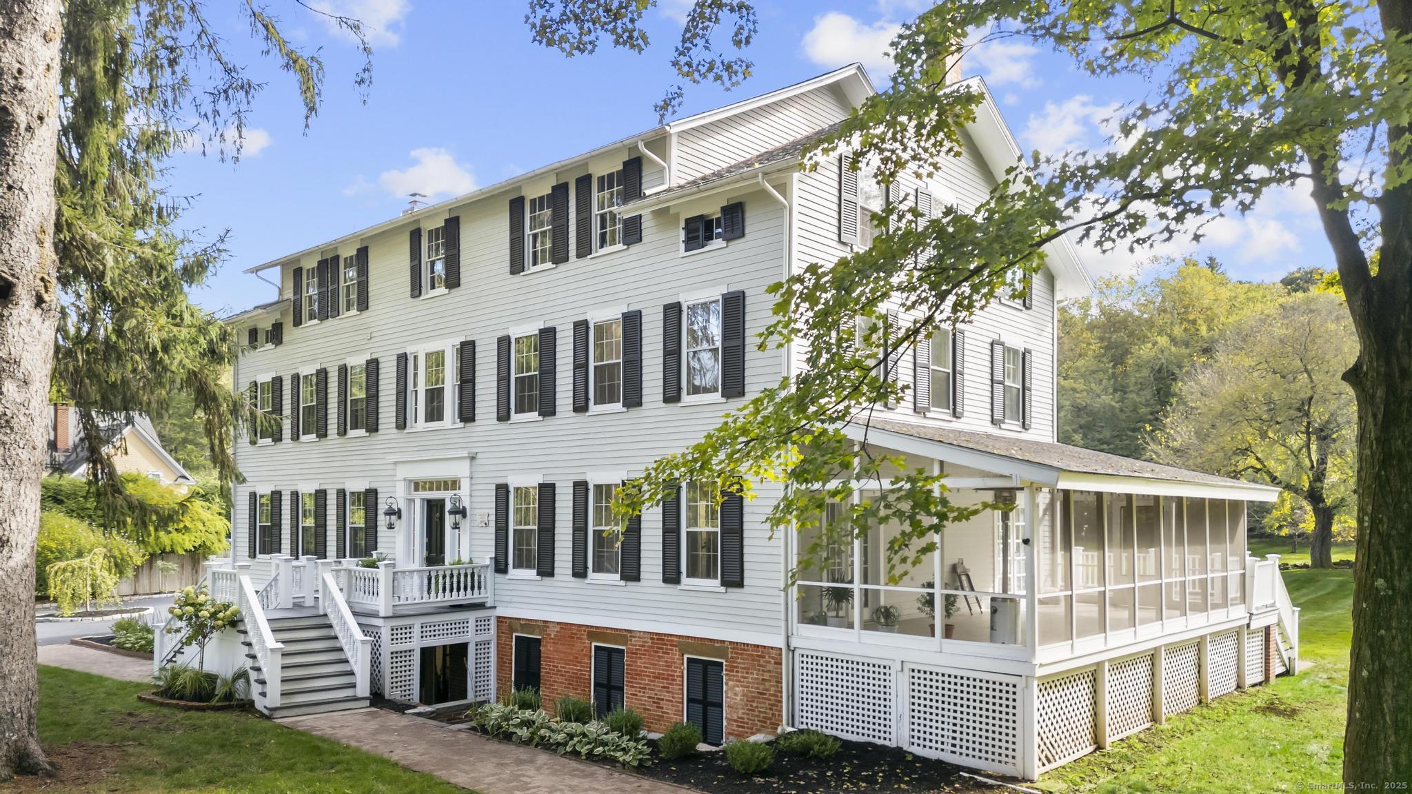 a view of building with large windows and a big yard