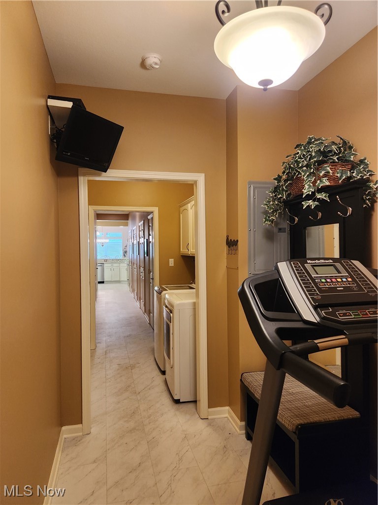 5645 Clingan Road, Unit 18A Struthers, OH 44471 - Photo 35 of 38 Mudroom area by Garage featuring light marble finish flooring, washer and dryer, electric panel & exercise equipment