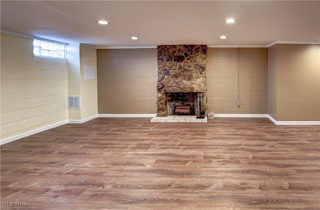 4234 Grafton Road Brunswick, OH 44212 - Photo 23 of 40 Family room featuring ornamental molding, hardwood / wood-style floors, and a fireplace