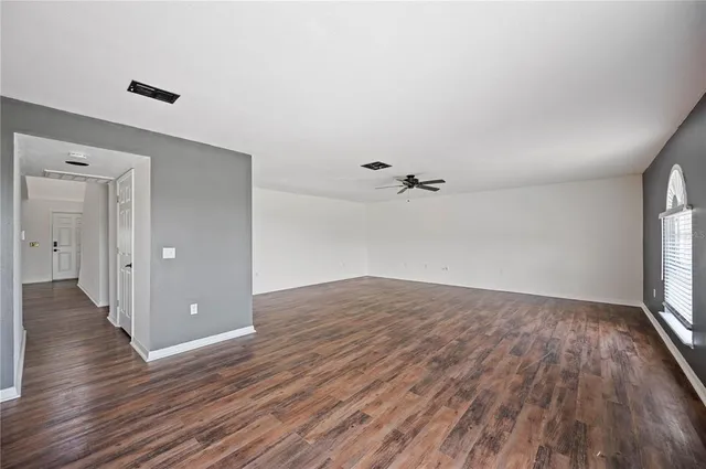 wooden floor in an empty room with a window