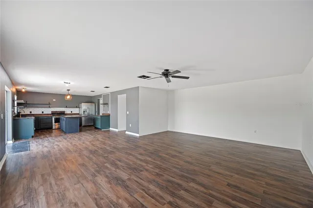 a view of a kitchen with a sink and a large window