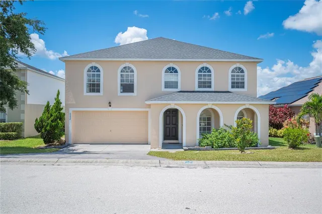 a front view of house with garage and yard