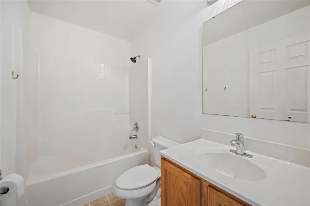 a bathroom with a sink toilet vanity and shower