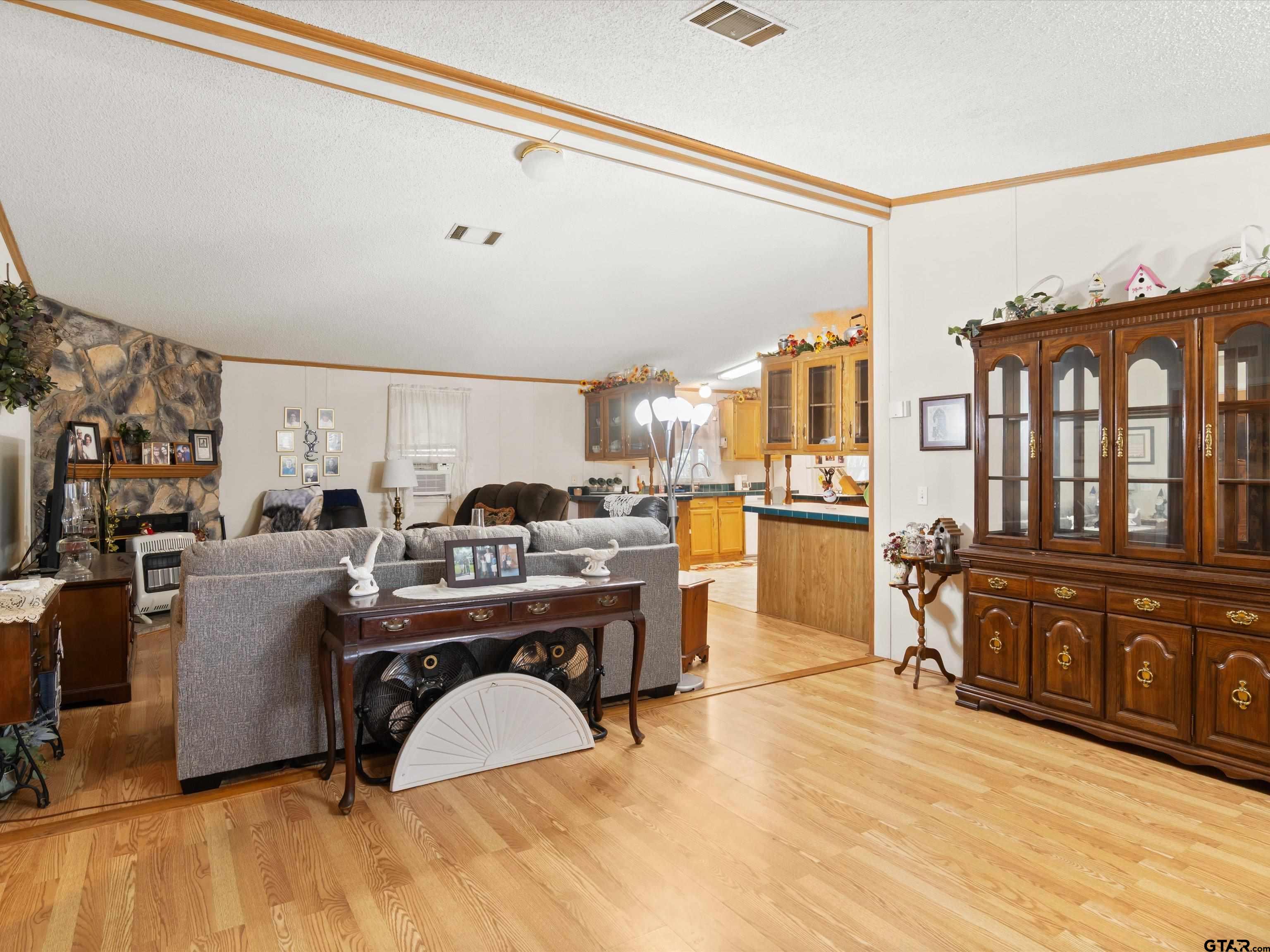 2811 Medlin Road Gilmer, TX 75645 - Photo 11 of 30 a living room with furniture and a kitchen view