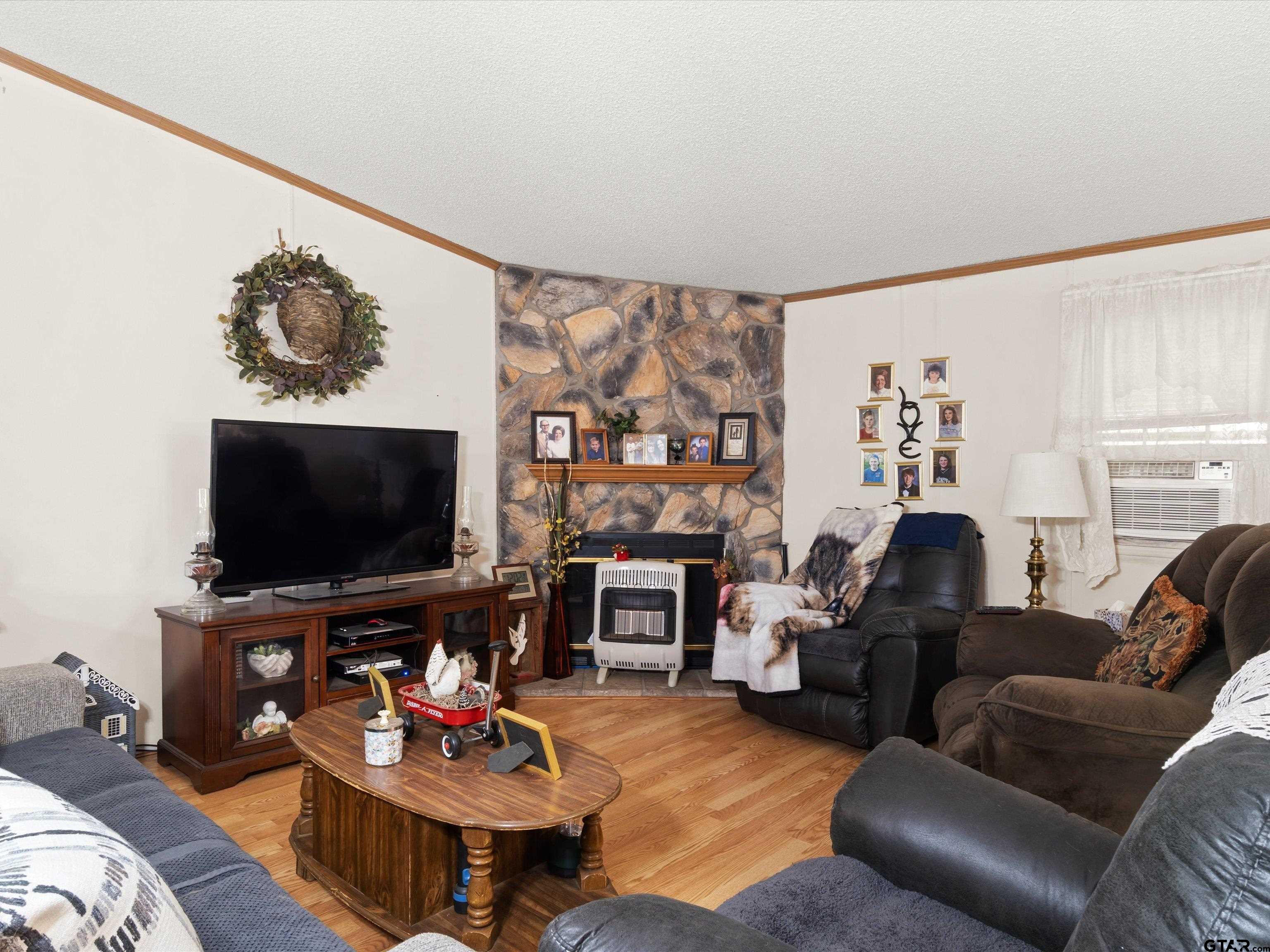 2811 Medlin Road Gilmer, TX 75645 - Photo 12 of 30 a living room with furniture and a flat screen tv