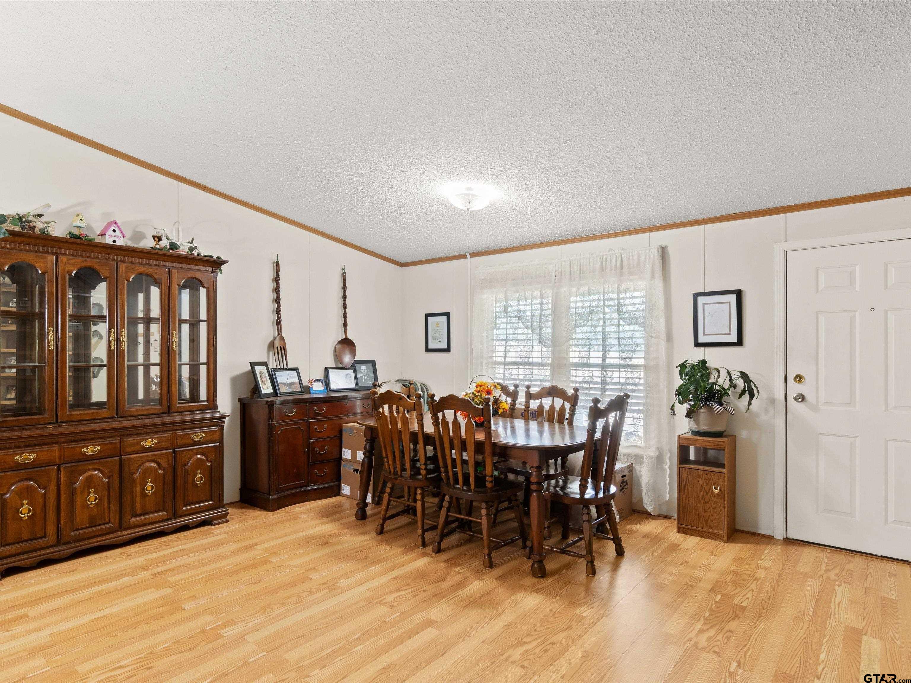 2811 Medlin Road Gilmer, TX 75645 - Photo 14 of 30 a view of a a dining room with furniture window and wooden floor