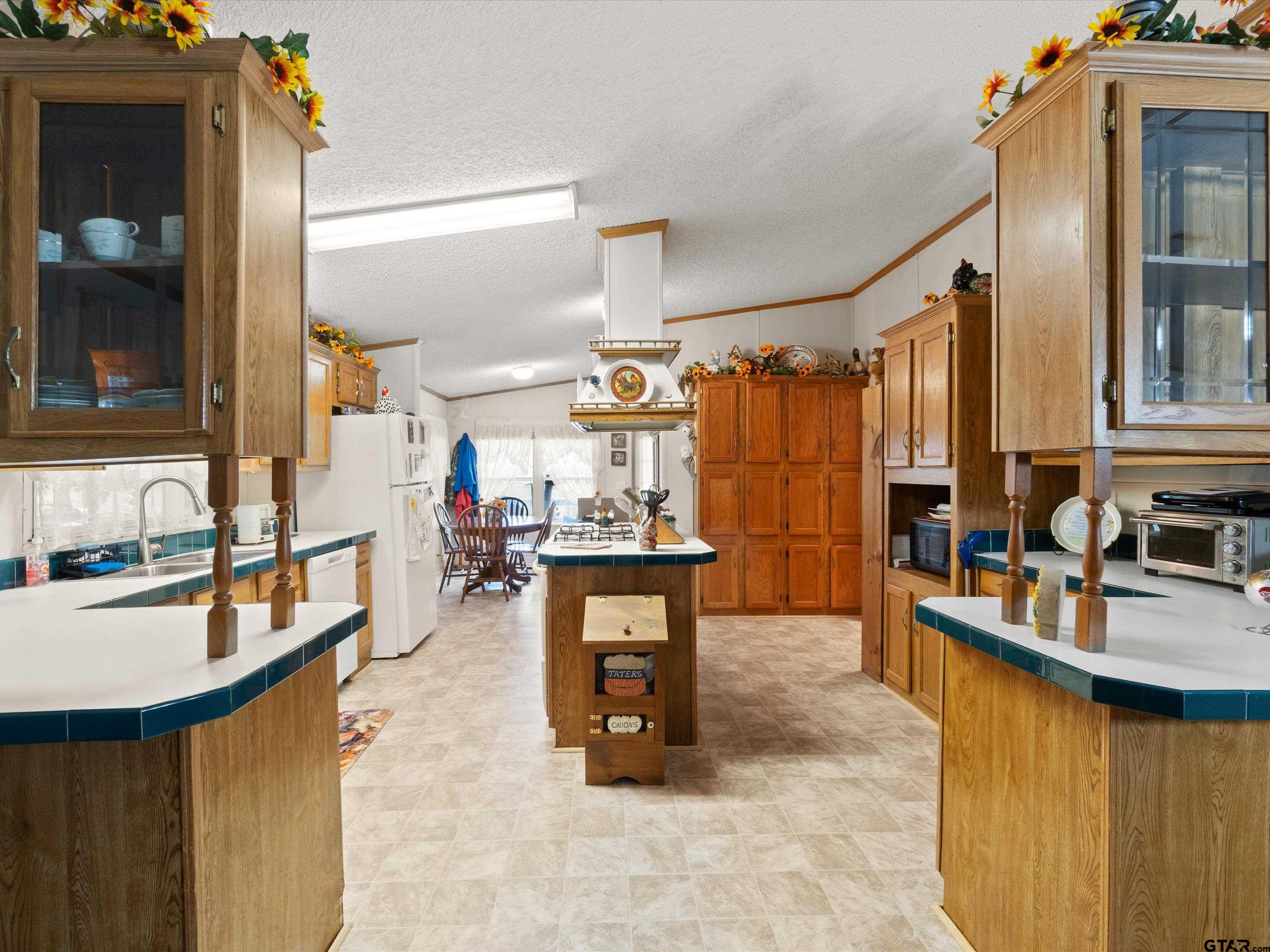 2811 Medlin Road Gilmer, TX 75645 - Photo 17 of 30 a kitchen view with granite countertop lots of counter top space