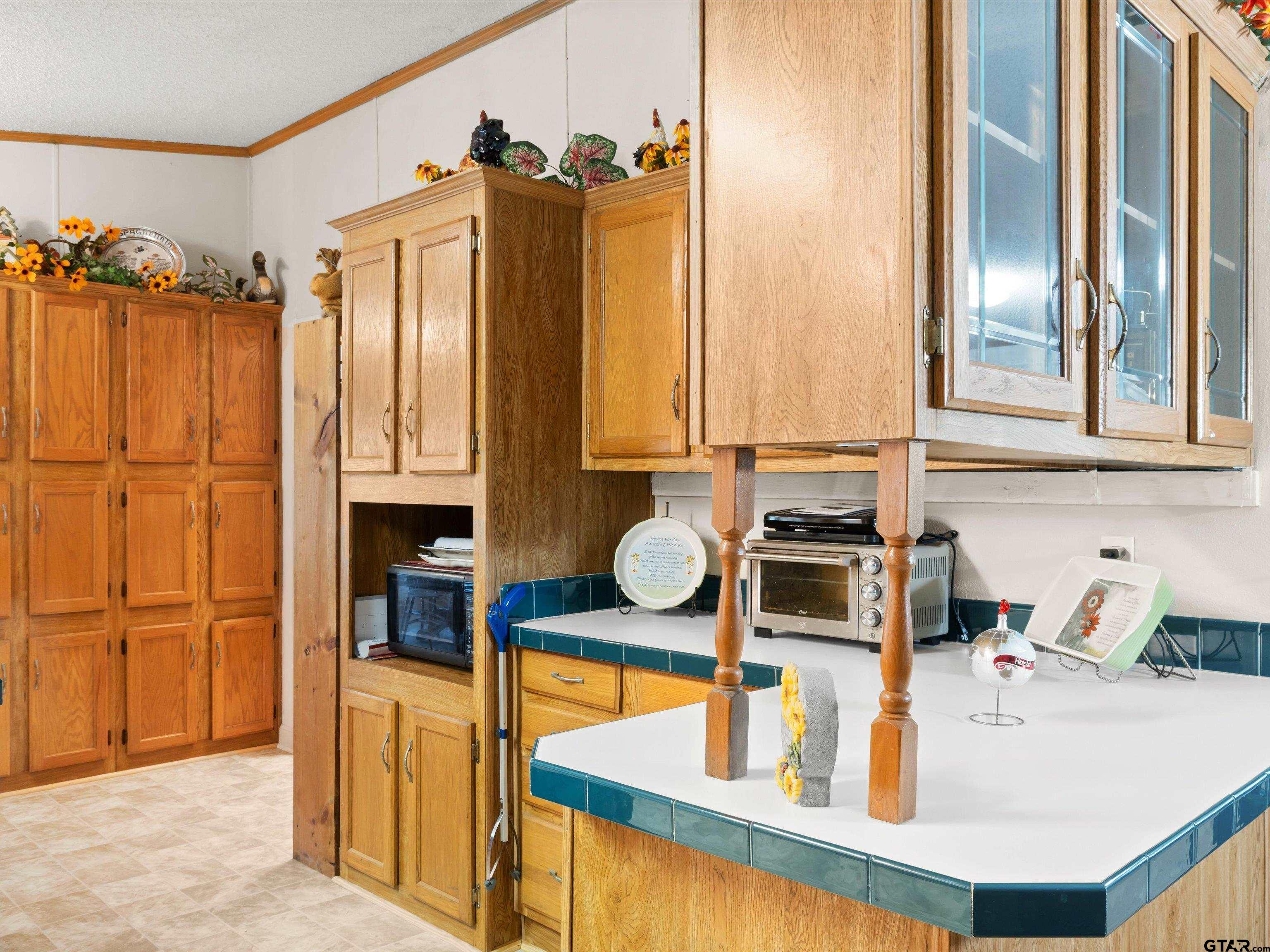 2811 Medlin Road Gilmer, TX 75645 - Photo 18 of 30 a kitchen with stainless steel appliances granite countertop a sink and a refrigerator