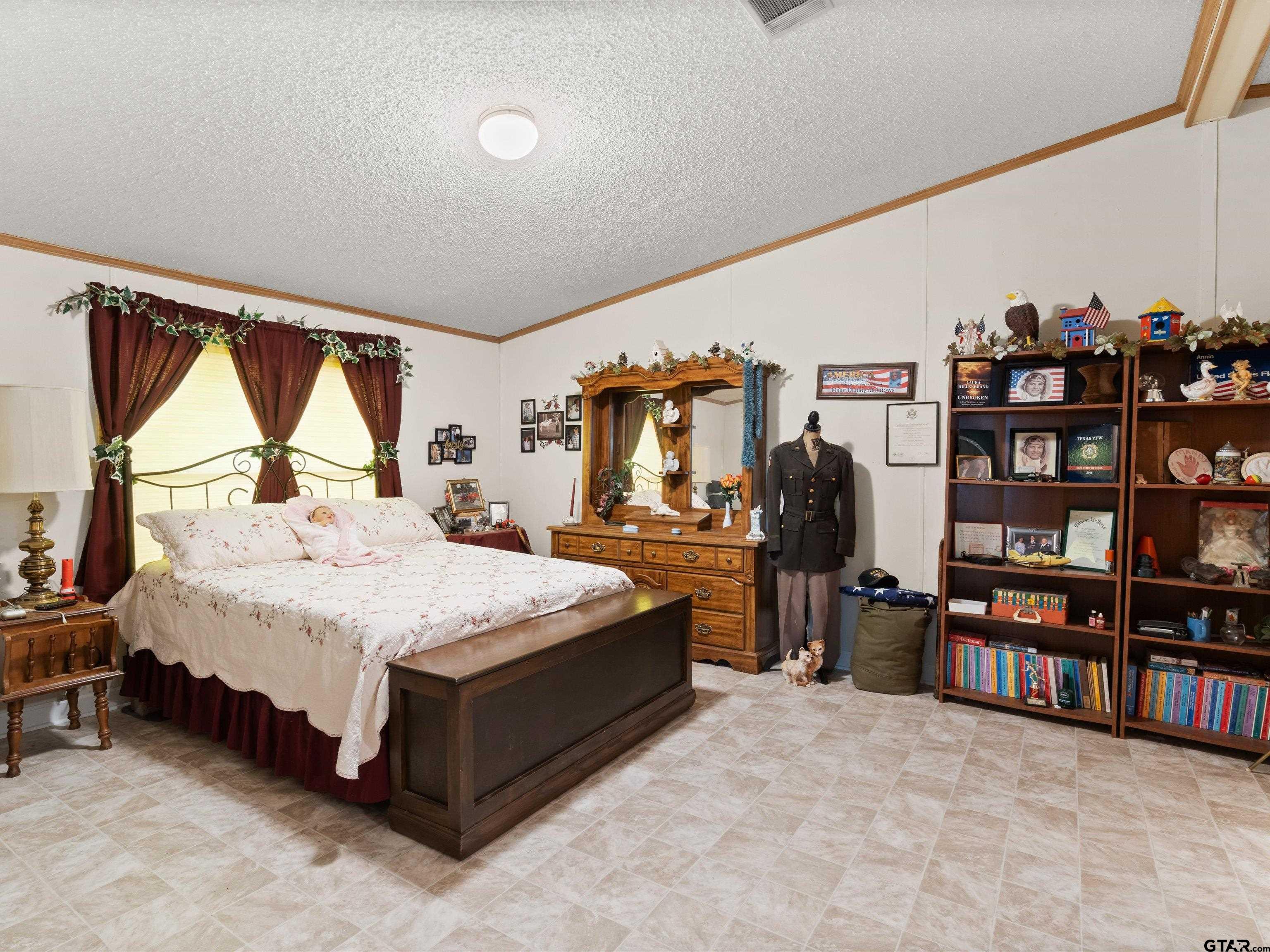 2811 Medlin Road Gilmer, TX 75645 - Photo 22 of 30 a spacious bedroom with a bed and a large window